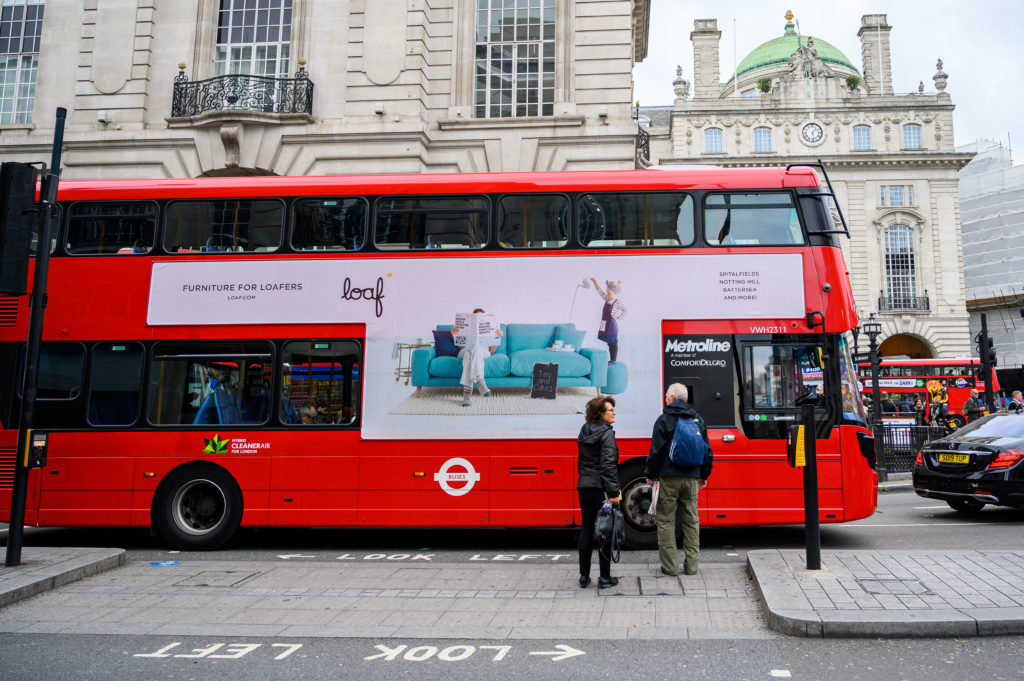 Photo of a bus with an advert for furniture brand Loaf on the side