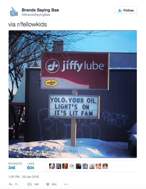 A sign from Jiffy Lube that says "YOLO YOUR OIL LIGHT'S ON IT'S LIT FAM"