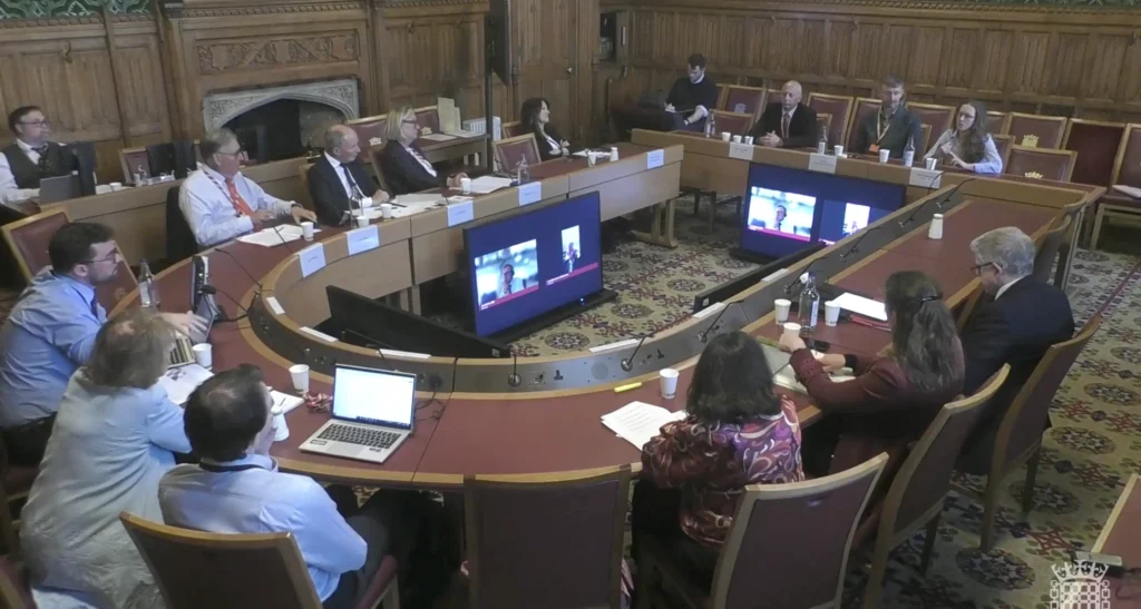 Charlie Marchant and other invited guest speakers at the Palace of Westminster addressing the Home-based Working Committee 