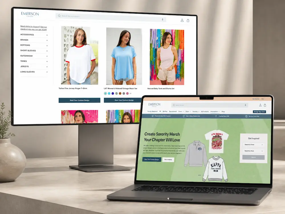 A monitor and laptop display the Emerson Chase website, showing a product catalog page with women's tops and a "Create Sorority Merch Your Chapter Will Love" landing page, on a desk with a decorative vase and plant.