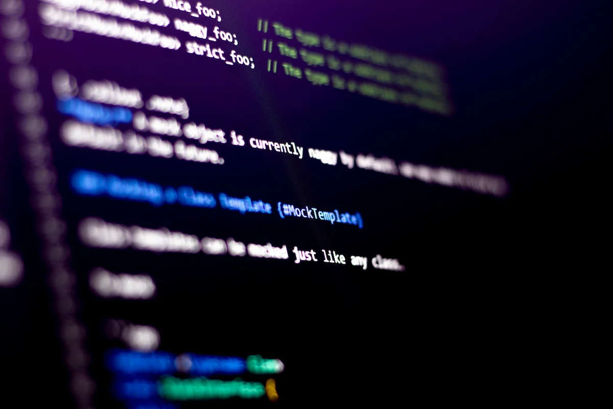 A dimly lit computer screen displays code documentation with syntax-highlighted text against a dark background.